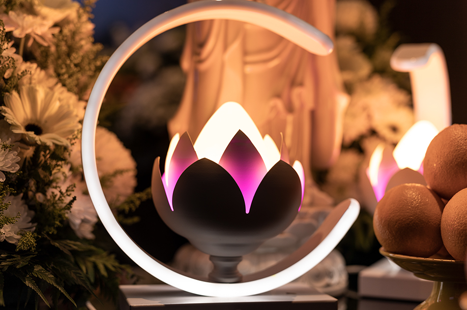 A luminous lotus lamp at the altar casting a gentle glow